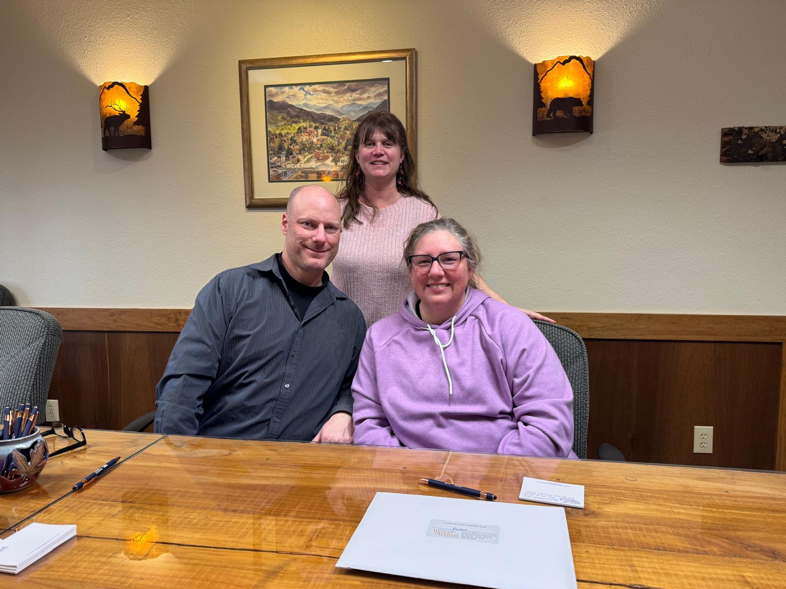 Sandy Alvear with clients at closing day Charlotte border